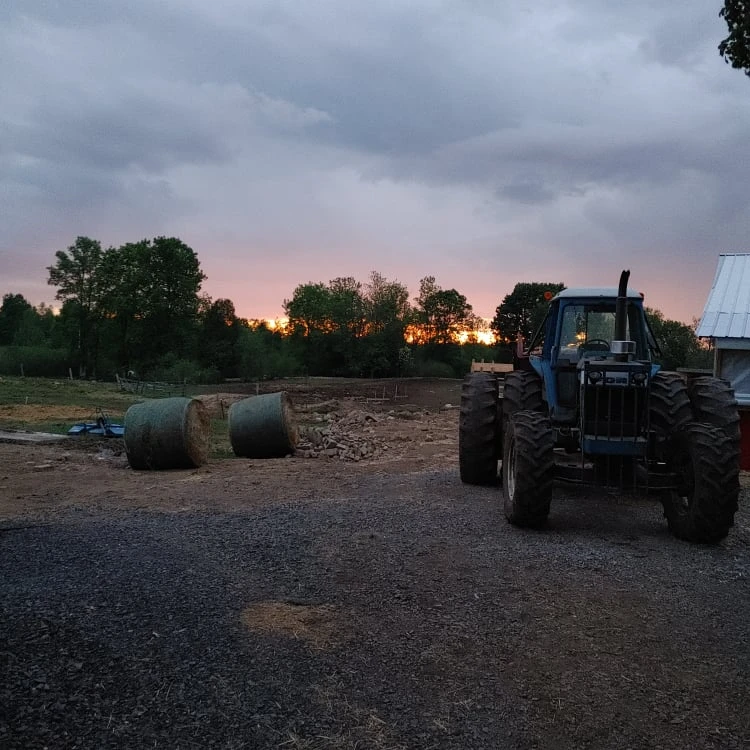 Tractor at sunset on the farm
