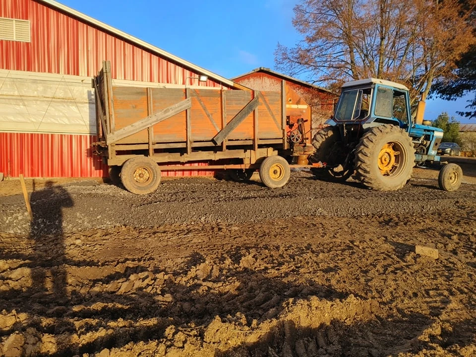 Tractor and wagon by the barn