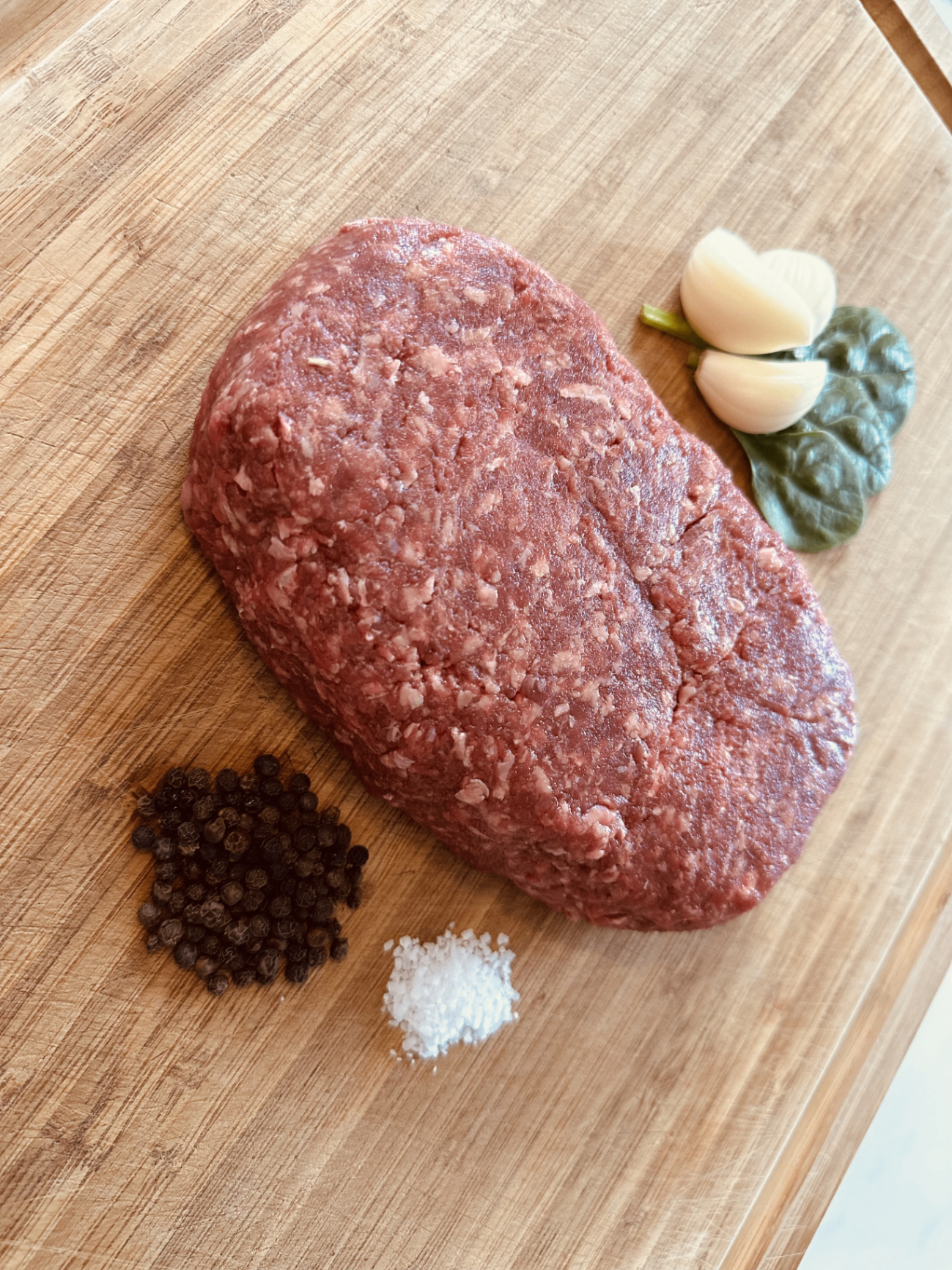 Fresh pasture-raised ground beef on a cutting board